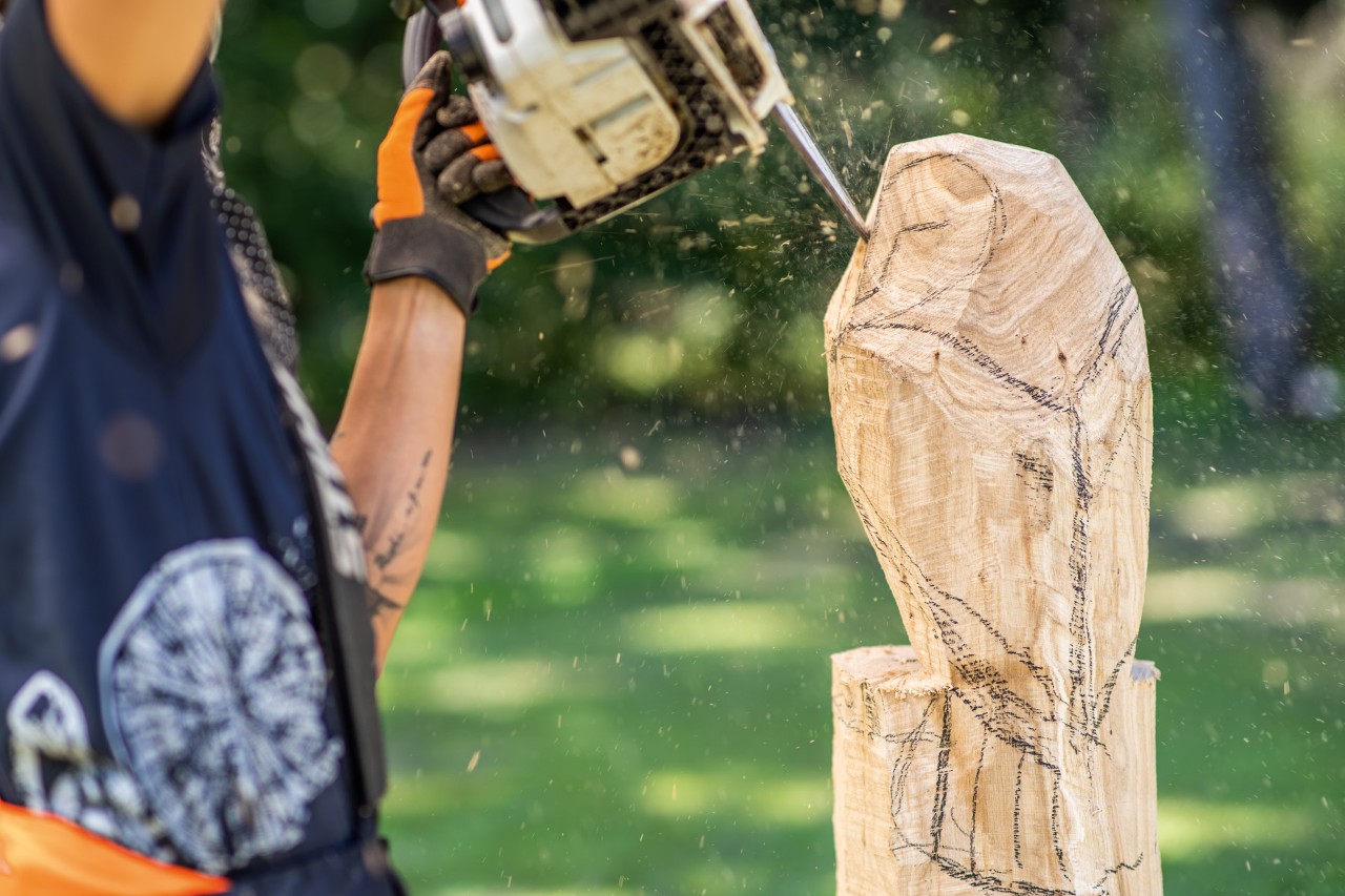 Ajout de détails sur une première ébauche de hibou sculpté avec une tronçonneuse STIHL et  son kit de sculpture